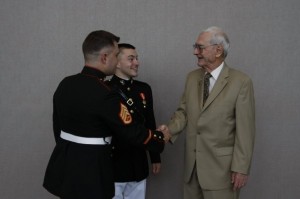 My brother and I shaking the hand of my grandfather.