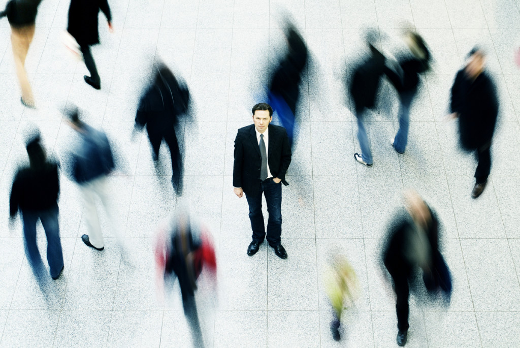 Business man surrounded by people