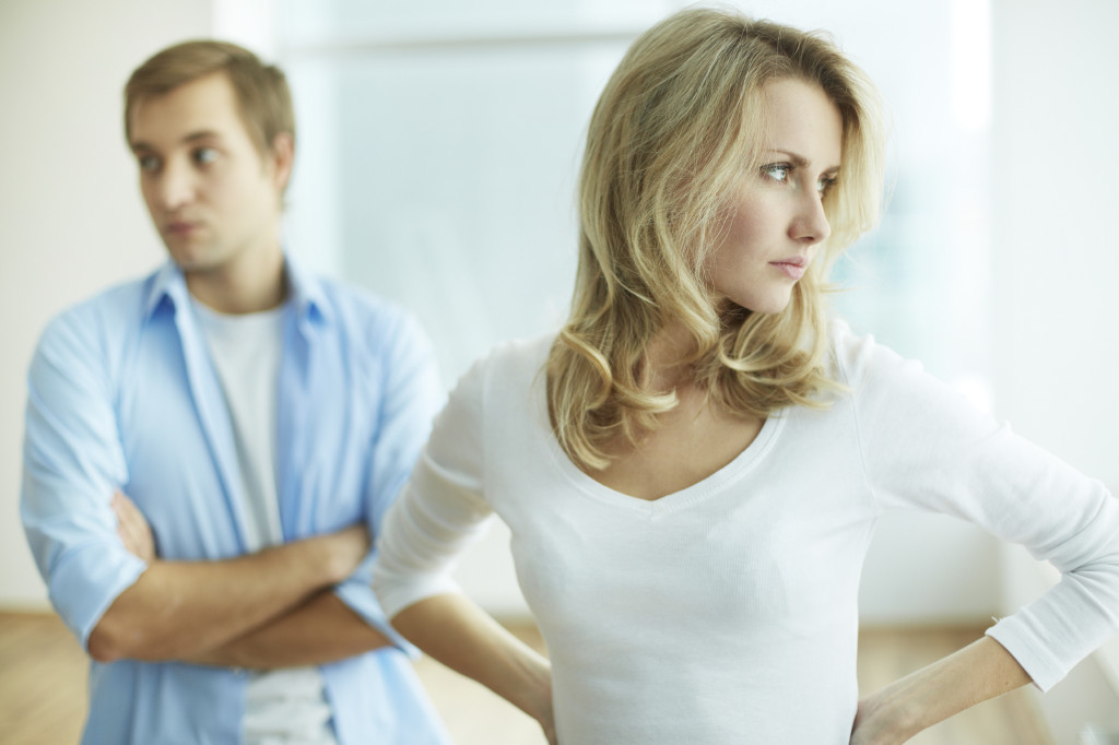 Image of young upset female in quarrel with her husband